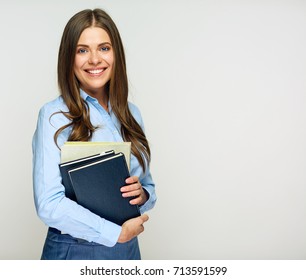 Smiling woman student, teacher or business lady holding books. Isolated studio portrait of business person. - Shutterstock ID 713591599