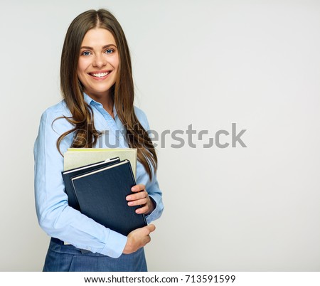 Smiling woman student, teacher or business lady holding books. Isolated studio portrait of business person.