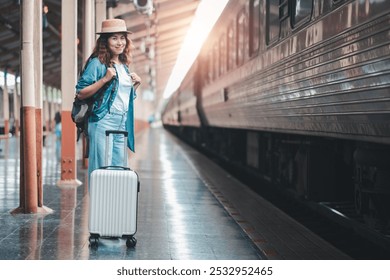 Smiling woman with suitcase and backpack at train station, ready for travel adventure. - Powered by Shutterstock