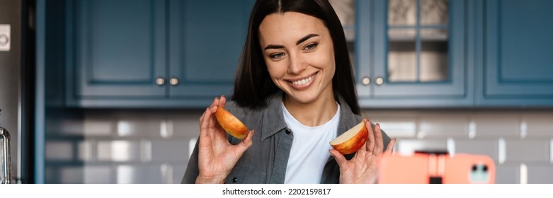 Smiling Woman Taking Selfie Footage With Apple On Cellphone At Home Kitchen