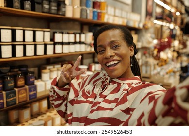 Smiling Woman Taking Selfie in Specialty Store - Powered by Shutterstock