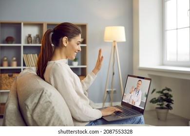 Smiling Woman Talk On Video Call With Doctor On Lockdown At Home. Happy Female Patient Have Webcam Virtual Conversation With GP On Computer. Distant Consultation With Medical Specialist.