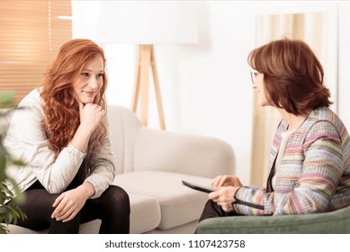 Smiling woman talking to a wellness coach to find motivation to achieve physical health goals - Shutterstock ID 1107423758