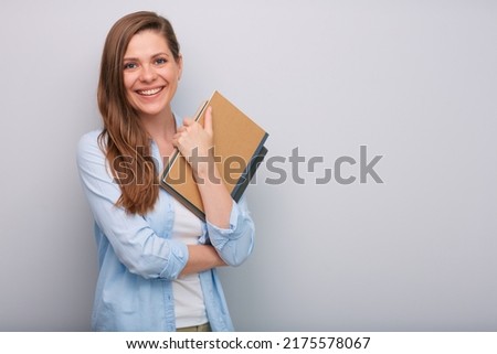 Smiling woman teacher or student holding book or workbook isolated portrait  