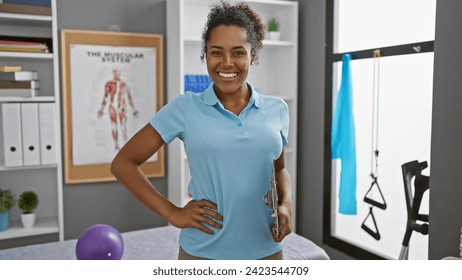 Smiling woman therapist holding clipboard in a well-equipped physical therapy clinic interior. - Powered by Shutterstock