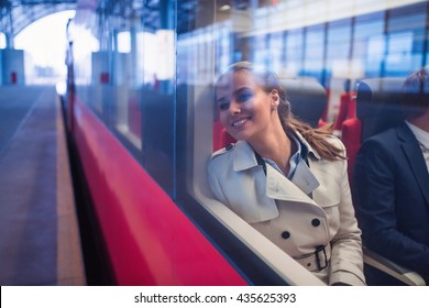 Smiling woman in a train