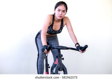 Smiling woman training on exercise bike