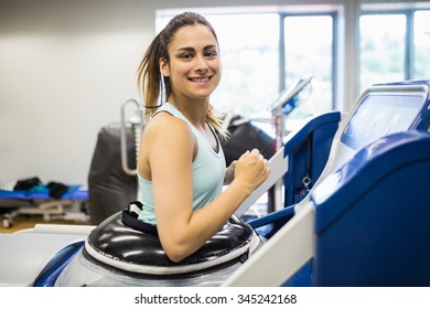 Smiling Woman Using An Anti Gravity Treadmill At The Gym