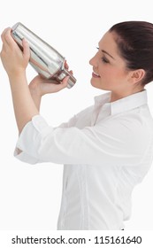 Smiling Woman Using Cocktail Shaker While Looking At It