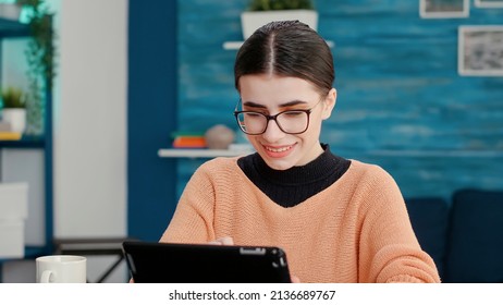 Smiling Woman Using Digital Gadget To Take Lecture Notes, Studying On Online School Lesson. Person Working On Tablet With Stylus To Browse Internet And Plan Project For Homework Assignment.