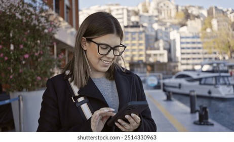 Smiling woman using smartphone by the istanbul waterfront with boats and cityscape in the background. - Powered by Shutterstock