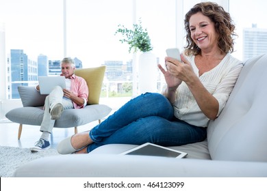 Smiling Woman Using Smartphone At Home