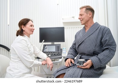 Smiling woman uzist communicates with a patient - Shutterstock ID 2246197689