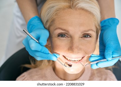 Smiling woman visiting dental cabinet for procedure - Powered by Shutterstock