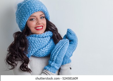 Smiling Woman Wearing Blue Winter Hat, Scarf And Mittens