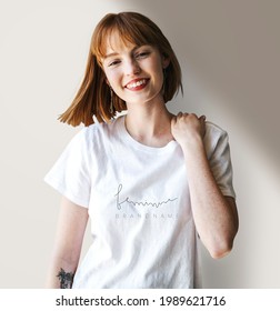 Smiling woman wearing a silk screenwhite t-shirt mockup