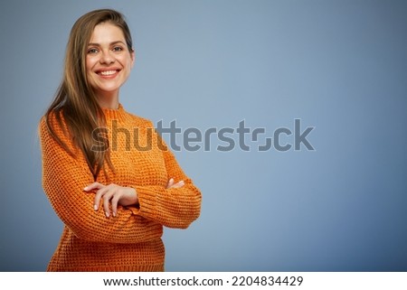 Smiling woman in winter knitted sweater, orange casual warm clothes. 