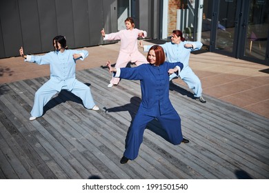 Smiling women captured at their tai chi training - Powered by Shutterstock