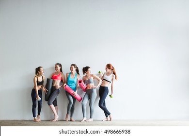 Smiling Women In Fitness Studio. Fitness, Sport, Training And Lifestyle Concept.