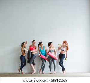 Smiling Women In Fitness Studio. Fitness, Sport, Training And Lifestyle Concept.