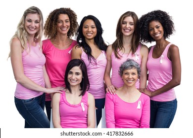 Smiling women in pink outfits posing for breast cancer awareness on white background - Powered by Shutterstock
