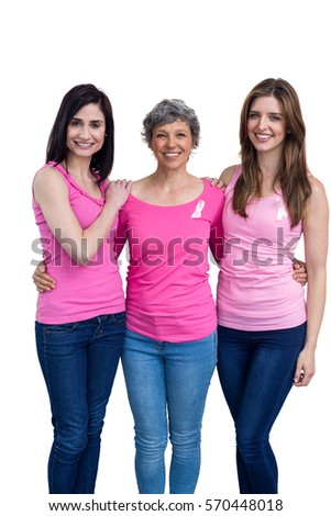 Smiling women in pink outfits posing for breast cancer awareness on white background