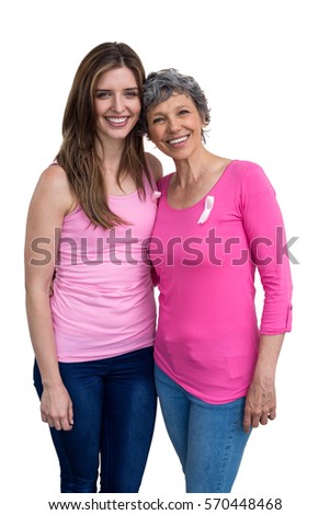 Smiling women in pink outfits posing for breast cancer awareness on white background