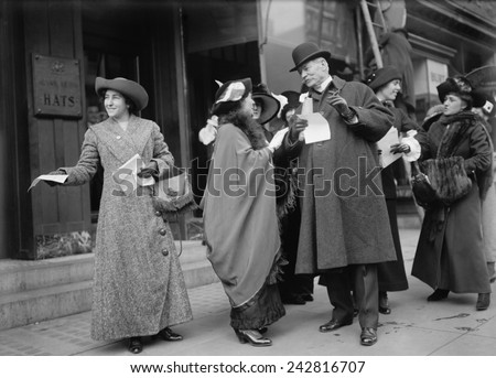 Smiling women suffragists hand out literature to advertise the 1913 parade in New York City.