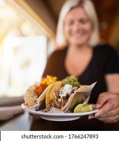 Smiling Women With Taco Food Plate In Her Hand