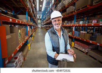 Smiling worker looking at camera in warehouse