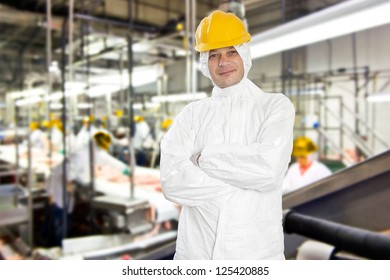 Smiling Worker In A Meat Processing Factory And Slaughterhouse, Wearing Hygienic Clothing