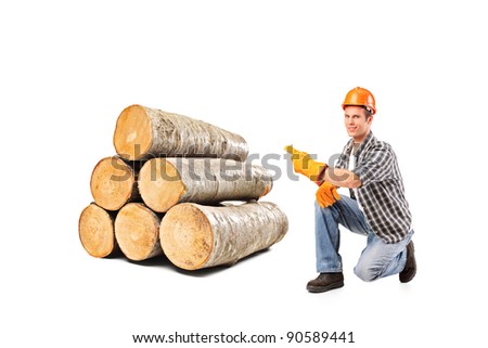A smiling worker pointing on a pile of beech firewood isolated on white background