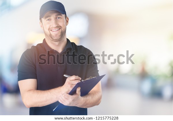 Smiling Worker Writing on\
Clipboard