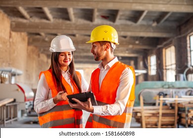 Smiling Workers Doing Work Using Tablet At Factory