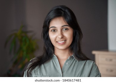 Smiling Young Adult Indian Woman Looking At Camera At Home Or In Office. Pretty Lady Standing In India House Apartment, Teacher, Real Estate Agent, Housewife Close Up Face Front Headshot Portrait.