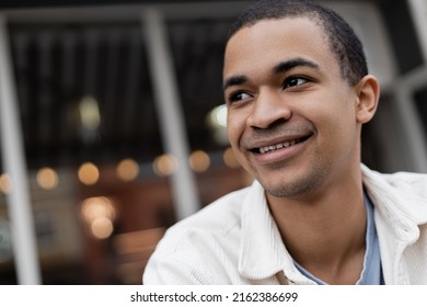 Smiling And Young African American Man Looking Away Outside