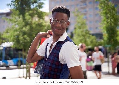 Smiling Young African American Man Carrying Shopping Bags And Looking At Camera