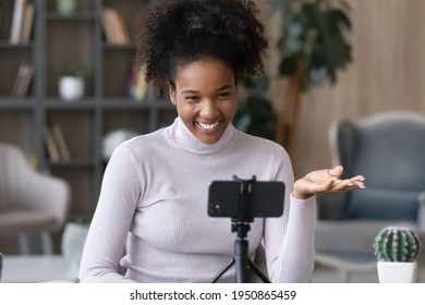 Smiling young African American woman use modern smartphone talk speak on video call on gadget. Happy millennial biracial female look at cellphone camera have webcam online lesson or virtual event. - Powered by Shutterstock