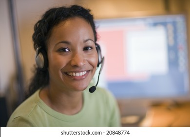 Smiling young African American woman with headset and microphone