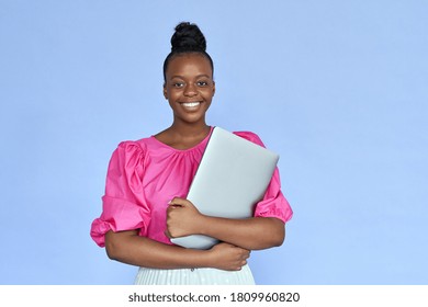 Smiling Young African Black Ethnic Woman Student Holding Laptop Computer In Hands Looking At Camera Isolated On Lilac Violet Mauve Studio Background, Portrait. Remote Job And Online Learning Concept.