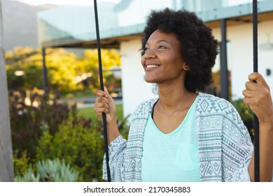 Smiling Young Afro African American Woman Looking Away Outside House. Unaltered, Lifestyle And Simple Living Concept.