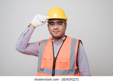 Smiling Young Asian Civil Engineer Wearing Helmet Hard Hat Standing On Isolated White Background. Mechanic Service Concept.