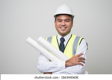 Smiling young asian civil engineer helmet hard hat standing showing thumbs up on isolated white background. Mechanic service concept.