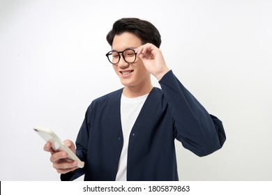 Smiling Young Asian Man Using Phone Over White Background.