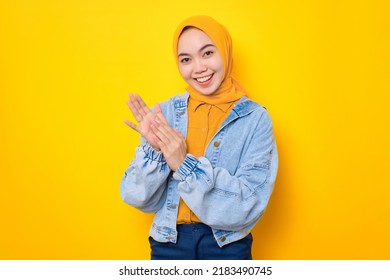 Smiling Young Asian Woman In Jeans Jacket Clapping Hands, Celebrating Success, Congratulating Someone Isolated Over Yellow Background