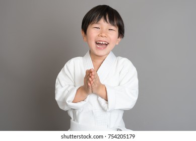 Smiling young athlete boy wearing judugi