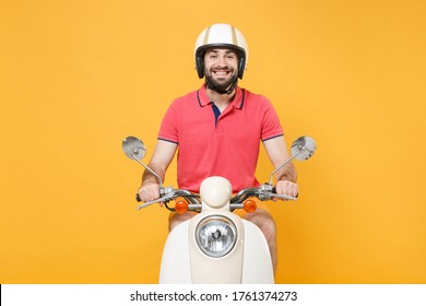 Smiling Young Bearded Man Guy In Casual Summer Clothes Helmet Driving Moped Isolated On Yellow Background Studio Portrait. Driving Motorbike Transportation Concept. Mock Up Copy Space. Looking Camera