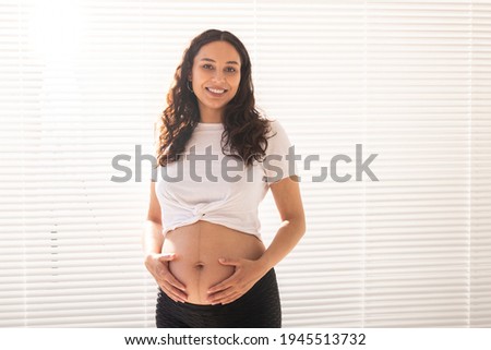 Similar – pregnancy Feminine