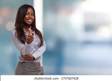 Smiling Young Black Business Woman Giving Thumbs Up