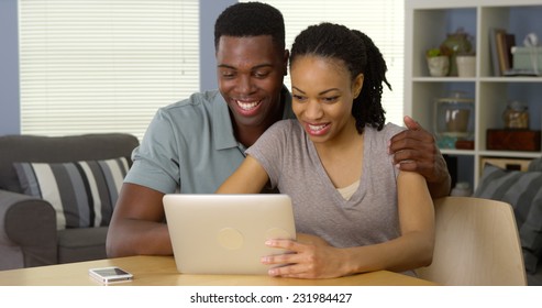 Smiling Young Black Couple Waving And Having Video Chat With Family Over Tablet